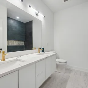 Second floor bathroom with double vanity and tub
