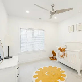 Nursery in home at The Enclave at Chestnut Hill with crib and dresser