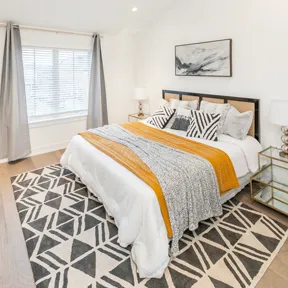 Primary bedroom featuring ample windows and space for large bed available at The Enclave at Chestnut Hill