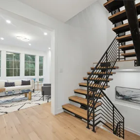First floor stairs in home at The Enclave at Chestnut Hill with view of family room