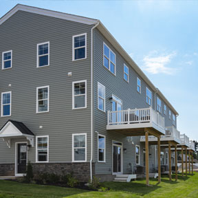 Rear exterior of the new homes built in Chalfont, PA featuring a deck off the second floor 