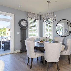 The Hamilton dining room featuring wide wood plank flooring with large windows and sliding glass door 