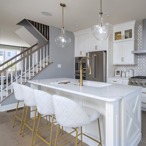 Open kitchen of the Hamilton model home in Chalfont, featuring stainless steel appliances, and island.