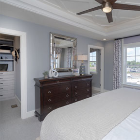 Owner's bedroom of the Hamilton with large windows, walk in storage area, and door to the en suite