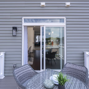 Reserve at Chalfont outdoor deck of the Jordan model home with sliding glass door and seating
