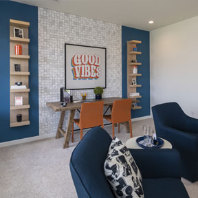 The Jordan great room at Reserve at Chalfont with carpeting and desk set up for work or school