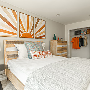 Bedroom of the Jordan model home at The Reserve at Chalfont with large bed, dresser, and closet