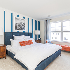 Owner's bedroom of the Jordan model featuring wall to wall carpeting and recessed lighting