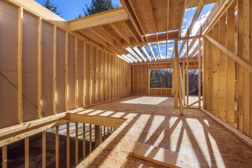 New framing house construction with no roof and two by fours exposed