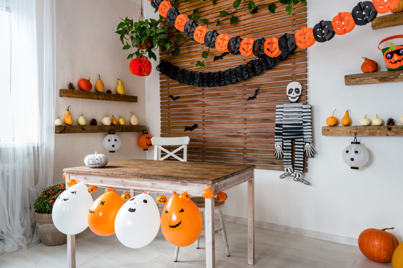 Halloween theme decorated living room. Lifestyle Halloween season family house interior. Traditional Halloween decorations background.