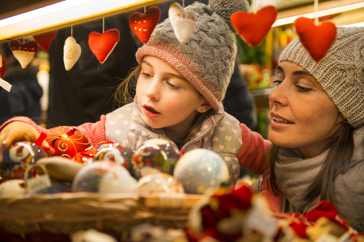 mother and daughter selecting decoration on a Christmas market