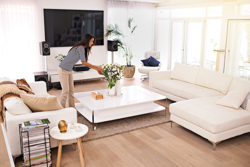 Woman tidying the living room