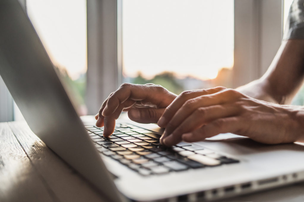 Person typing on a computer