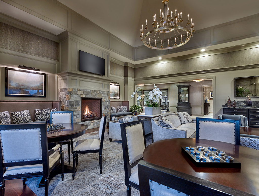 Clubhouse community seating area with table games and a fireplace
