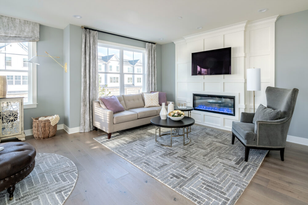 Living room with natural light and electric fireplace at a Judd Builders home for sale